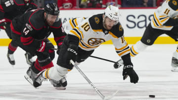 Jan 29, 2023; Raleigh, North Carolina, USA;  Boston Bruins left wing A.J. Greer (10) is tripped by