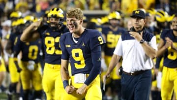 Michigan Wolverines quarterback J.J. McCarthy (9) celebrates on the sidelines during action against