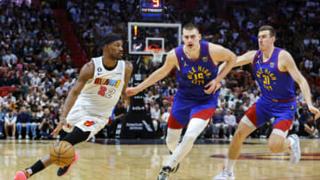 Miami Heat forward Jimmy Butler (22) dribbles the basketball ahead of Denver Nuggets center Nikola Jokic (15). (Sam Navarro-USA TODAY Sports)