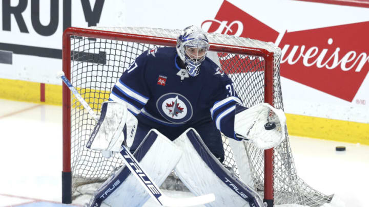 Apr 22, 2023; Winnipeg, Manitoba, CAN; Winnipeg Jets goaltender Connor Hellebuyck (37) warms up before a game against the Vegas Golden Knights in game three of the first round of the 2023 Stanley Cup Playoffs at Canada Life Centre. Mandatory Credit: James Carey Lauder-USA TODAY Sports