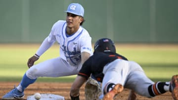CHAPEL HILL, NORTH CAROLINA - APRIL 01: Gage Gillian #15 of the North Carolina Tar Heels tags Carson DeMartini #4 of the Virginia Tech Hokies out at second base during the second inning at Boshamer Stadium on April 01, 2022 in Chapel Hill, North Carolina. (Photo by Eakin Howard/Getty Images)
