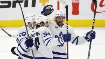 SUNRISE, FL - APRIL 10: Teammates congratulate Auston Matthews #34 of the Toronto Maple Leafs after he scored a second period goal against the Florida Panthers at the FLA Live Arena on April 10, 2023 in Sunrise, Florida. (Photo by Joel Auerbach/Getty Images)